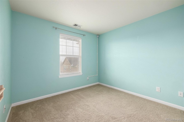 carpeted spare room with baseboards