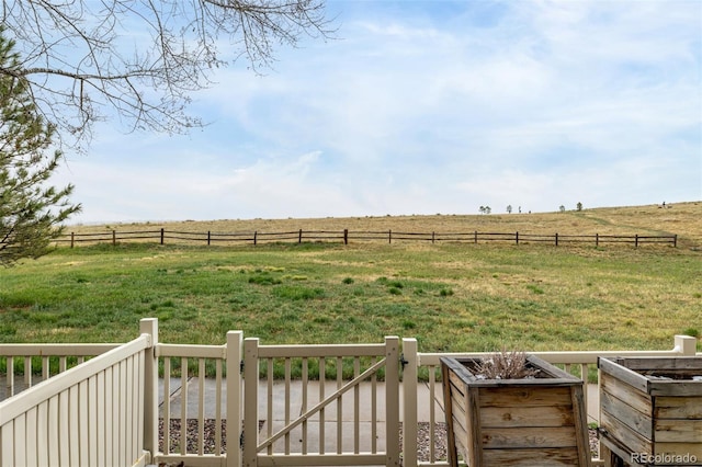 view of yard featuring fence and a rural view