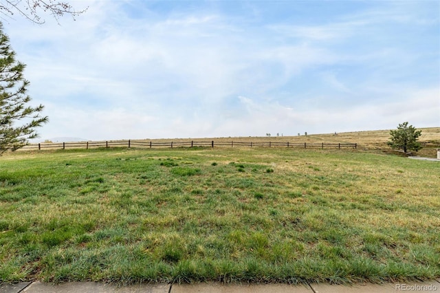 view of yard featuring a rural view and fence