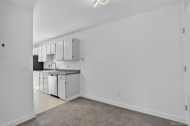 7902 Chase Cir Unit 152, Arvada, CO 80003 - kitchen with stainless steel dishwasher, light carpet, dark countertops, and white cabinetry