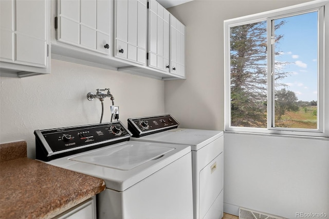 7902 Chase Cir Unit 152, Arvada, CO 80003 - laundry area featuring cabinet space, plenty of natural light, and washing machine and dryer