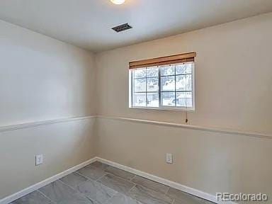 unfurnished room featuring visible vents and baseboards