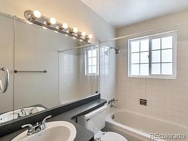 full bathroom featuring vanity, toilet, and washtub / shower combination