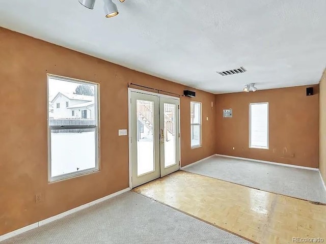 doorway to outside with visible vents, french doors, and baseboards