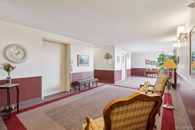 living room featuring carpet and a textured ceiling