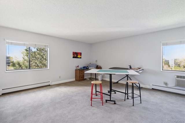 office area with a baseboard radiator, carpet floors, baseboard heating, an AC wall unit, and a textured ceiling
