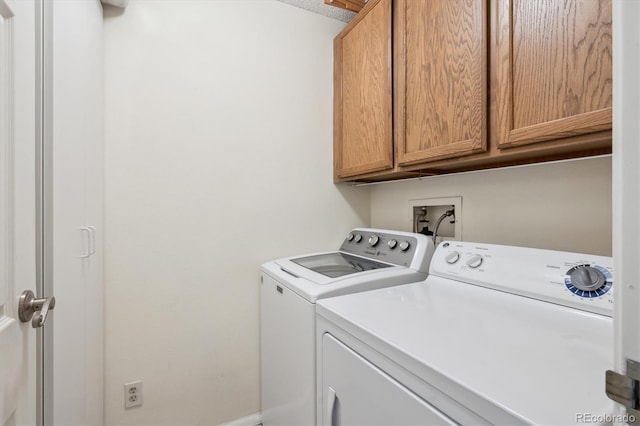 laundry area with cabinet space and washer and dryer