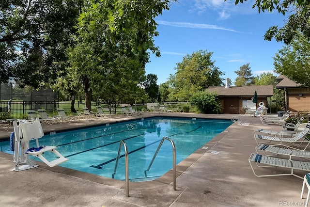 community pool featuring fence and a patio area
