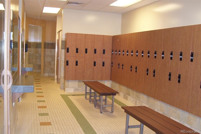 community lobby featuring wainscoting and tile walls