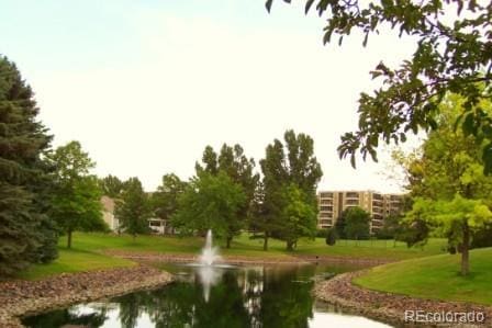 view of community featuring a water view and a lawn