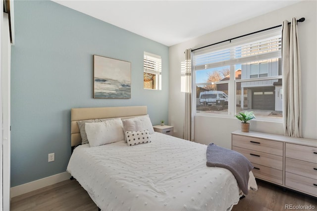 bedroom with dark hardwood / wood-style floors