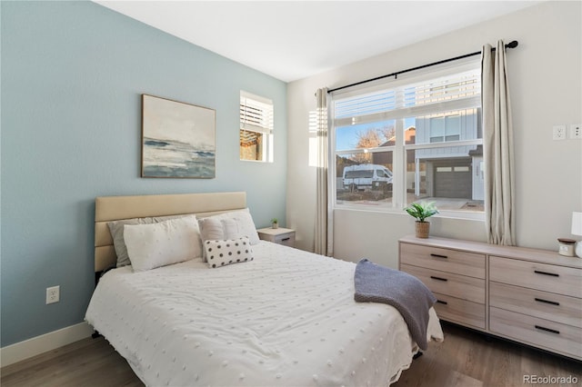 bedroom featuring dark wood-type flooring and multiple windows