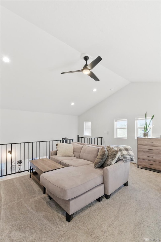 carpeted living room featuring ceiling fan and vaulted ceiling