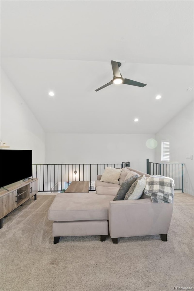 living room with lofted ceiling, light colored carpet, and ceiling fan