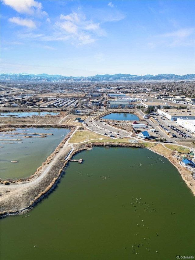 drone / aerial view with a water and mountain view