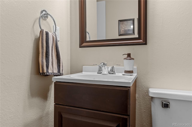 bathroom with toilet and vanity