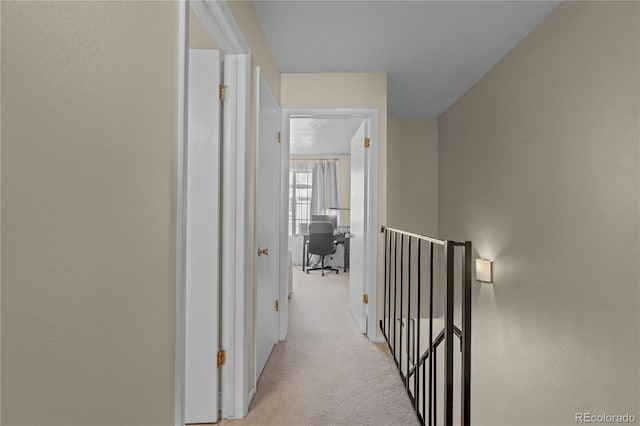 hallway with light colored carpet