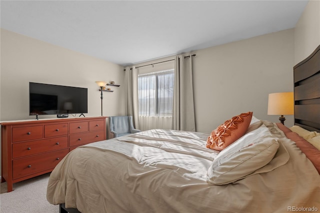 bedroom featuring light carpet