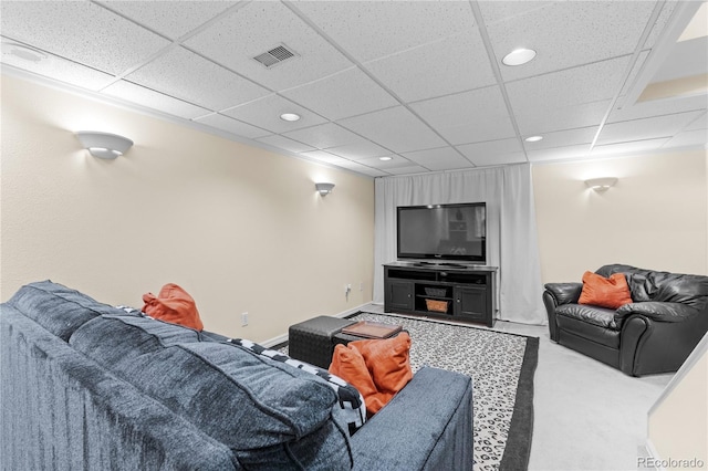 carpeted living room with a drop ceiling