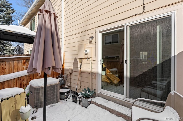 snow covered patio featuring central air condition unit