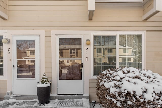 view of snow covered property entrance