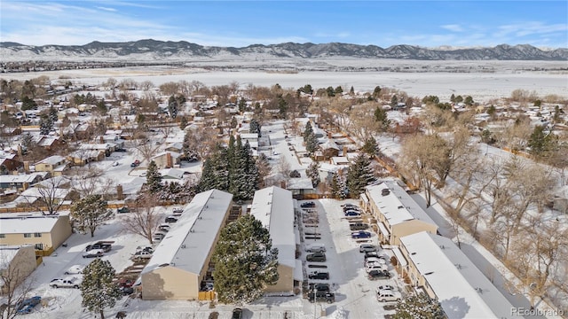 snowy aerial view featuring a mountain view