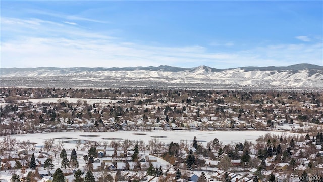 snowy aerial view featuring a mountain view