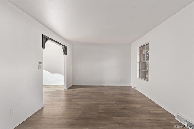 spare room featuring dark wood finished floors and visible vents