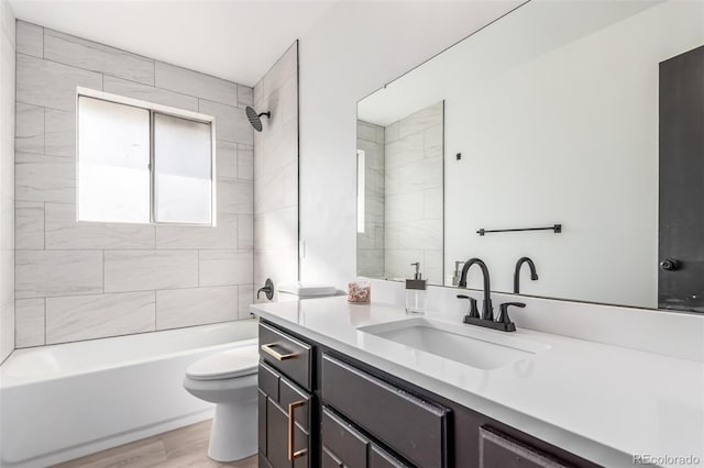 bathroom with wood finished floors, shower / bath combination, vanity, and toilet