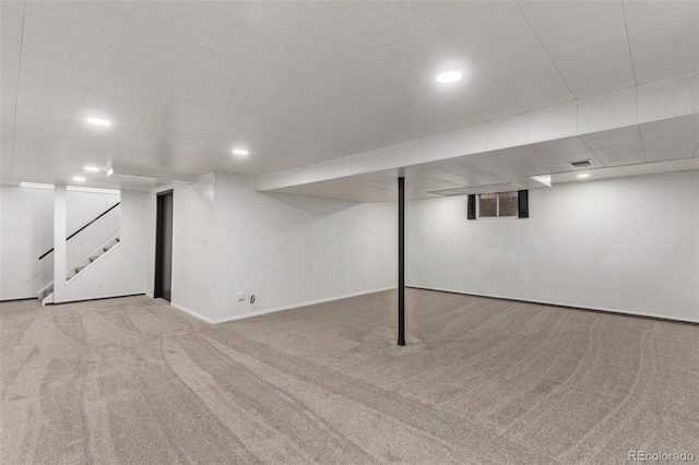 finished basement with carpet, stairs, baseboards, and recessed lighting