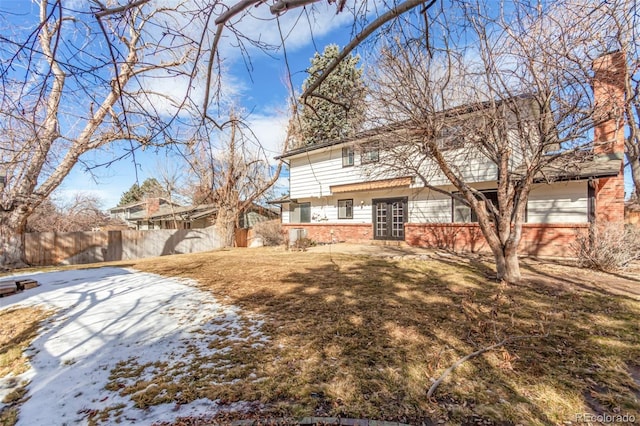 view of front of house featuring a yard and fence