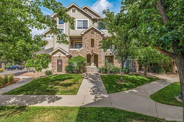 1535 S Florence Way Unit 410, Aurora, CO 80247 - view of front of property with stone siding and a front yard