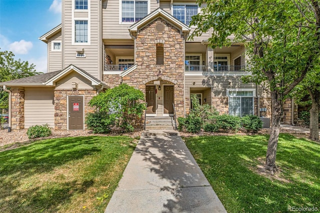 1535 S Florence Way Unit 410, Aurora, CO 80247 - view of front of house with stone siding and a front lawn