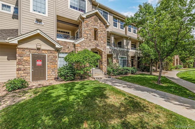 1535 S Florence Way Unit 410, Aurora, CO 80247 - view of front of house with stone siding and a front yard