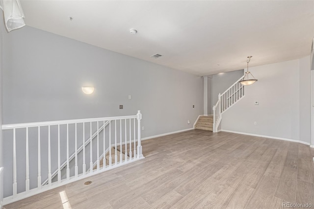 1535 S Florence Way Unit 410, Aurora, CO 80247 - spare room featuring light wood-style floors and stairs