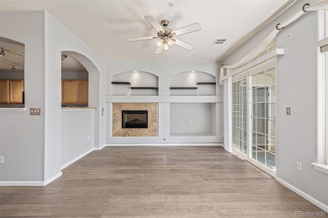 1535 S Florence Way Unit 410, Aurora, CO 80247 - unfurnished living room featuring ceiling fan, wood finished floors, and healthy amount of natural light