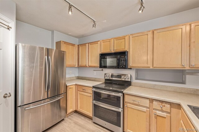 1535 S Florence Way Unit 410, Aurora, CO 80247 - kitchen with stainless steel appliances, light brown cabinets, track lighting, and light countertops