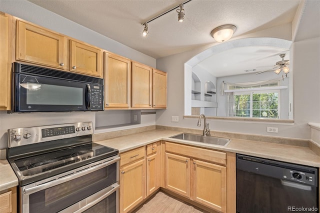 1535 S Florence Way Unit 410, Aurora, CO 80247 - kitchen with black appliances, light brown cabinets, ceiling fan, light countertops, and arched walkways