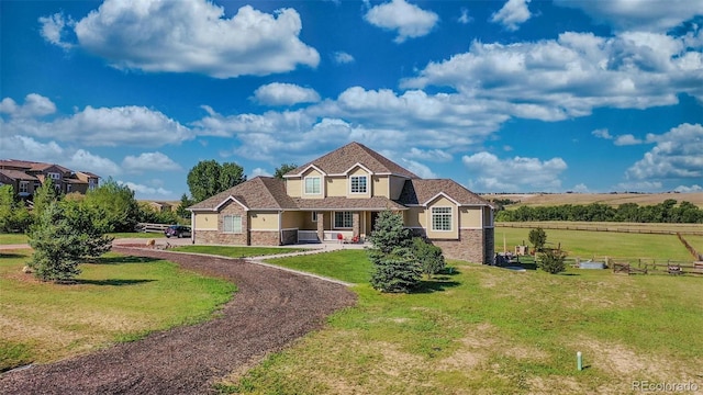 view of front of home featuring a front yard and a rural view