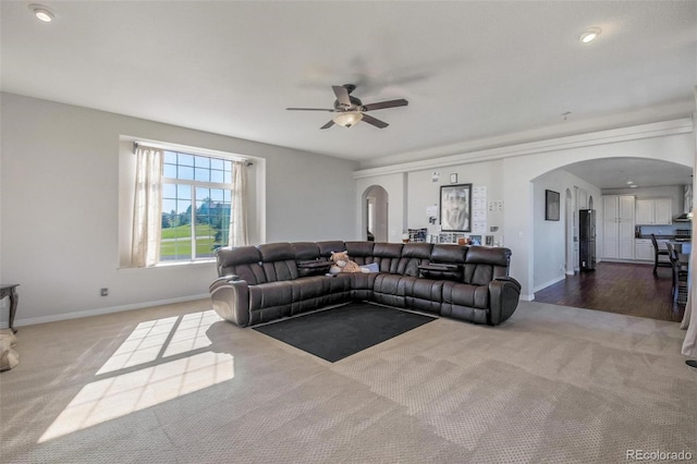 living room featuring ceiling fan and wood-type flooring