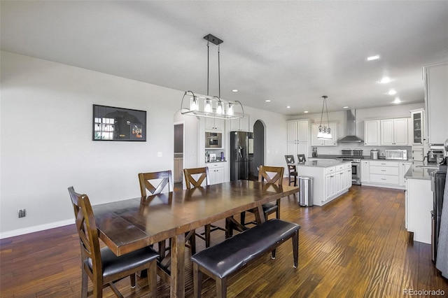 dining space with dark hardwood / wood-style flooring and sink