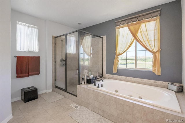 bathroom featuring a wealth of natural light, plus walk in shower, and tile patterned floors