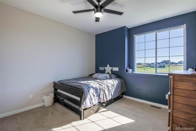 bedroom featuring ceiling fan and light carpet