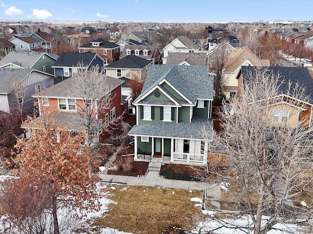 snowy aerial view featuring a residential view