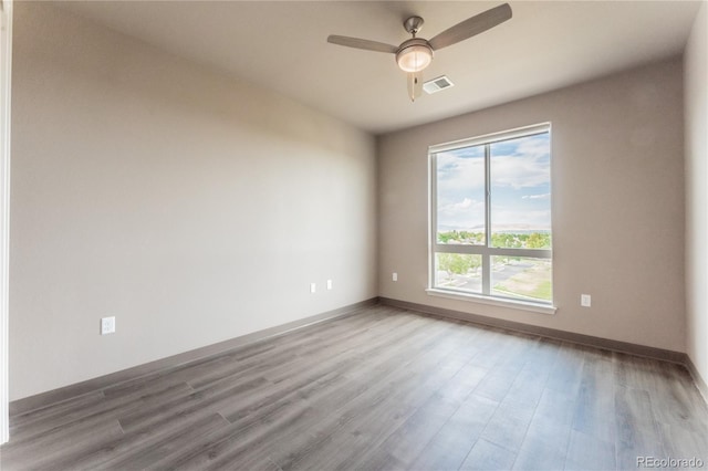 spare room with wood-type flooring and ceiling fan