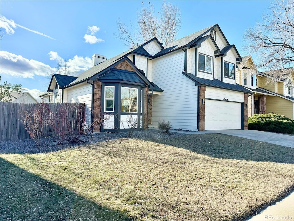 view of front of home with a garage and a front lawn