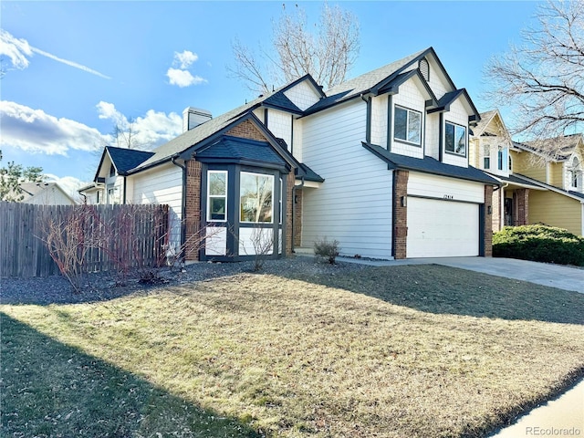 view of front of home with a garage and a front lawn