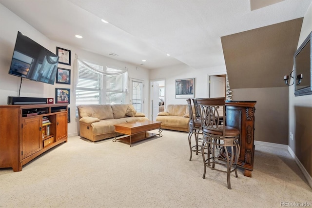 living room with recessed lighting, visible vents, and baseboards