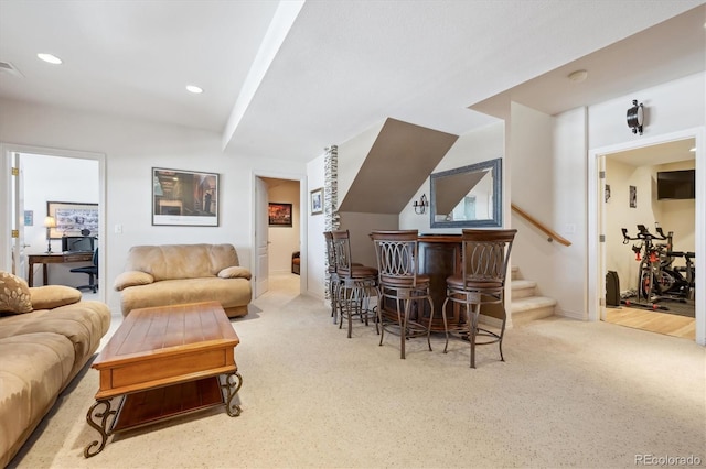 living area with recessed lighting, carpet, stairs, and a bar