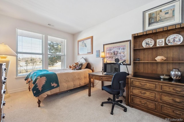 carpeted bedroom with baseboards and visible vents